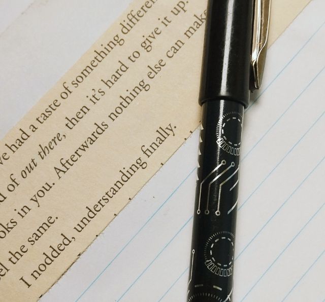 A piece of writing against a page from an exercise book and a black ball point ink writing pen. Photo by Siteri Rawada