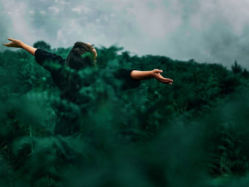 A free woman worships and prays outside in nature in a green field. Photo by Photo by Kourosh Qaffari from Pexels: https://www.pexels.com/photo/person-standing-on-grass-field-while-opening-hands-1583582/https://www.pexels.com/photo/person-standing-on-grass-field-while-opening-hands-1583582/