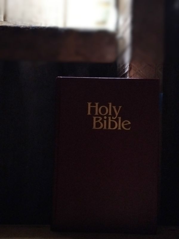 Atmospheric colour photo of a New King James Version of the Bible with brown hardcover for Bible study and meditation. Photo by Siteri Rawada, taken at Nadi, Fiji Islands with a Samsung Galaxy A05s smartphone.